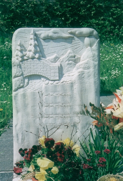 Grabstein mit gehauenem Steinbild einer Berglandschaft 