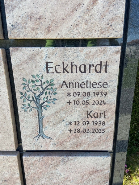 Beschriftete und mit gehauenem Baummotiv gestaltete Urnenwandplatte